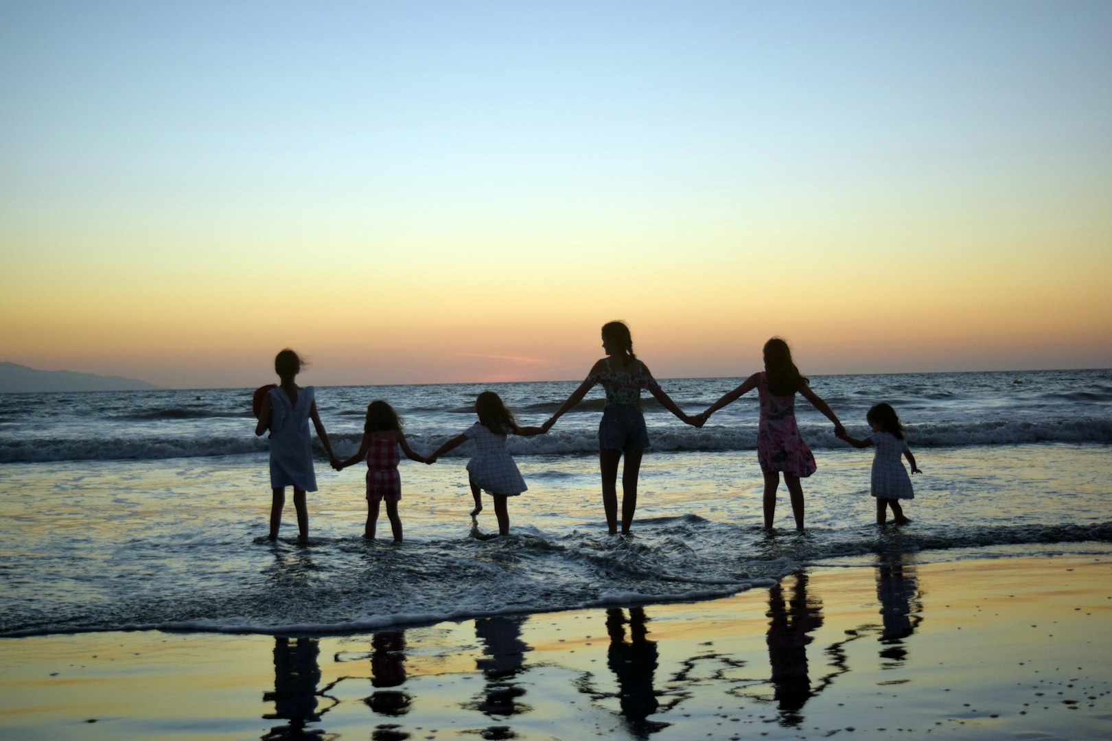A family at the beach during sunset